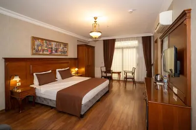 a hotel room with a large bed and a table at Hotel Blisstanbul in Istanbul