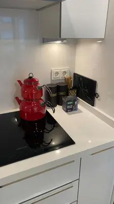 a red mixer sitting on a counter in a kitchen at Cebeci Chic and Cosy Apartments in Istanbul