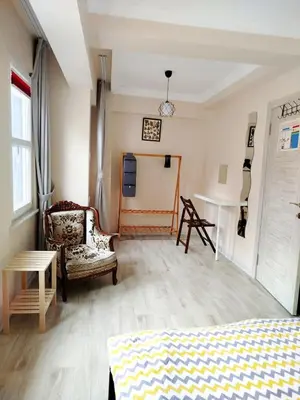 a bedroom with a bed and a chair and a table at İstanbulda merkezi pitoresk konum müstakil yeni ev in Istanbul
