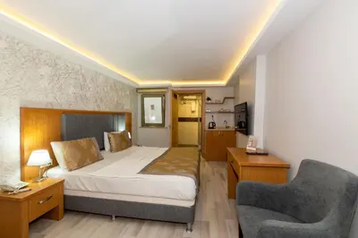 a hotel room with a bed and a chair at GalataportWawhotel in Istanbul