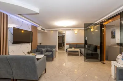 a living room with couches and a flat screen tv at GalataportWawhotel in Istanbul