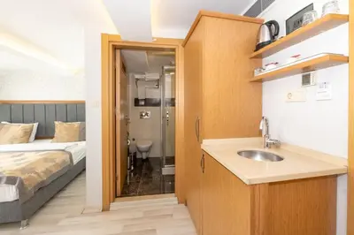 a bathroom with a sink and a bed in a room at GalataportWawhotel in Istanbul