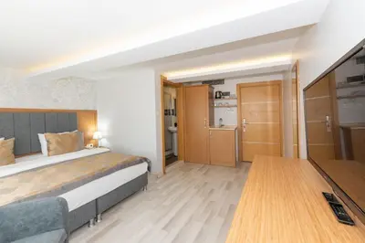 a bedroom with a bed and a wooden floor at GalataportWawhotel in Istanbul