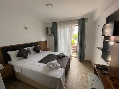 a hotel room with a bed with towels on it at ATAŞ AQUA OTEL AVŞA in Samanlı