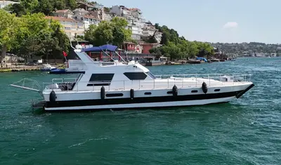 a white boat floating on the water in a river at PRUVA YACHT in Istanbul