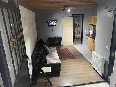 a living room with a couch and a tv on a wall at Mara Suite Taxim in Istanbul