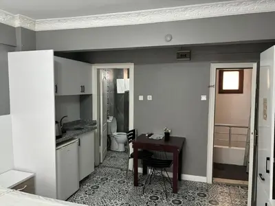 a kitchen with a desk and a sink and a bathroom at Mara Suite Taxim in Istanbul