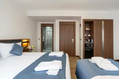 a bedroom with two beds with towels on them at THE BOSFOR HOTEL in Istanbul