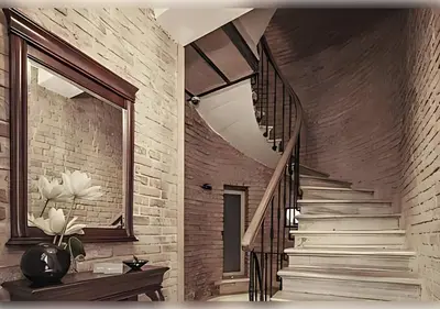 a staircase in a room with a brick wall at Baylo Suites in Istanbul