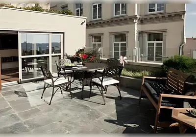 a patio with a table and chairs on a balcony at Baylo Suites in Istanbul