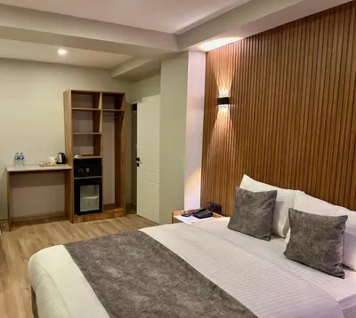 a bedroom with a large bed with two pillows at Skymoon Istanbul Airport Hotel in Arnavutköy