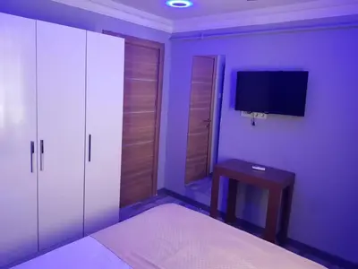 a purple bedroom with a bed and a tv at EYFEL HOTEL in Istanbul