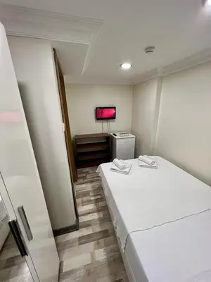 a room with a bed and a tv in it at EYFEL HOTEL in Istanbul