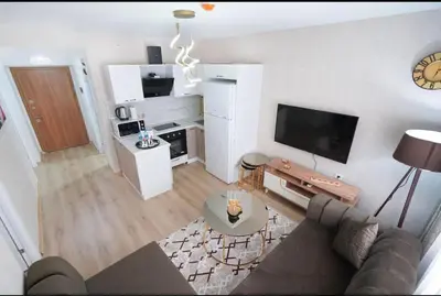 a living room with a couch and a tv at Two Bedroom King Deluxe Suite IS9 in Esenyurt