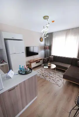 a living room with a couch and a tv at Two Bedroom King Deluxe Suite IS9 in Esenyurt