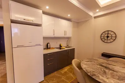 a kitchen with a white refrigerator and a table at Lilium Luxury Suites in Istanbul
