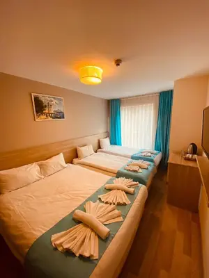 two beds in a room with towels on them at Ottoman Luxury Hotel in Istanbul