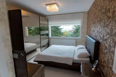 a bedroom with a bed and a large window at Bungalov Maşukiye Villa in Kartepe