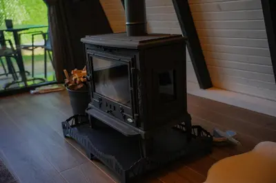 a black stove sitting on the floor in a room at Bungalov Maşukiye Villa in Kartepe