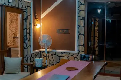 a room with a table and a fan on a wall at Bungalov Maşukiye Villa in Kartepe