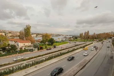 a busy highway with cars on it and a river at Waterfront Apartment by the Tram - Terrace with Dome & Golden Horn View in Fatih in Istanbul