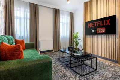 a living room with a green couch and a table at BayMari Suites City Life in Istanbul