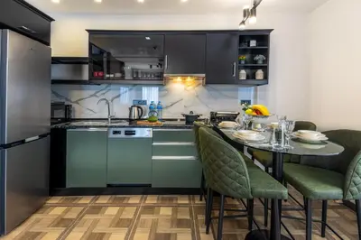 a kitchen with a table and chairs in a room at BayMari Suites City Life in Istanbul