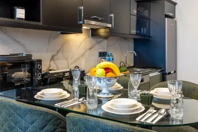 a kitchen with a table with a bowl of fruit on it at BayMari Suites City Life in Istanbul