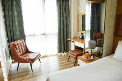 a hotel room with a bed and a desk and chair at The Hera Platinum Hotel in Istanbul