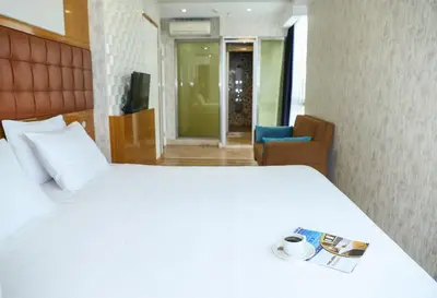 a hotel room with a bed and a cup of coffee at The Hera Platinum Hotel in Istanbul