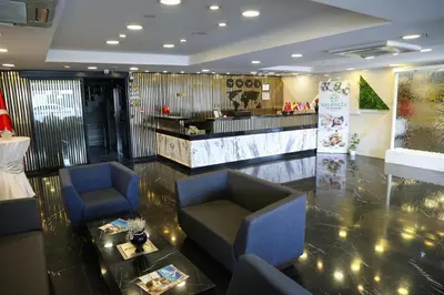 a lobby with two chairs and a table and a counter at The Hera Platinum Hotel in Istanbul