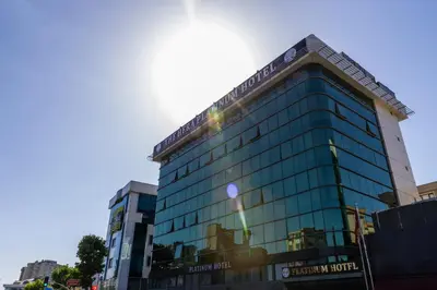 a tall glass building with the sun shining on it at The Hera Platinum Hotel in Istanbul