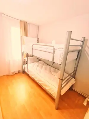two bunk beds in a room with a wooden floor at Taksim History Wooden Hostel in Istanbul