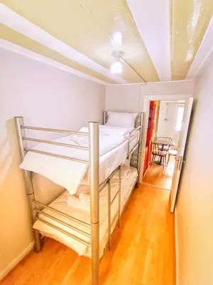 two bunk beds in a room with a table at Taksim History Wooden Hostel in Istanbul