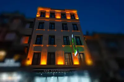 a tall white building with a green flag on it at Vera Life Hotel in Istanbul