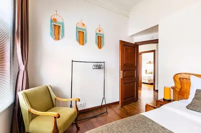 a bedroom with a bed and a chair and a mirror at Historical Greco-Ottoman Pavilion near Tram in Fatih in Istanbul