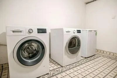 a washing machine and a dryer in a room at Historical Greco-Ottoman Pavilion near Tram in Fatih in Istanbul