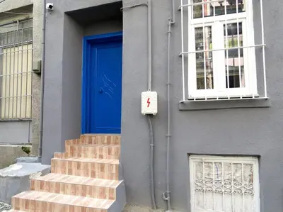 a blue door on a building with stairs and a window at Istanberry - Royal Apartments in Istanbul