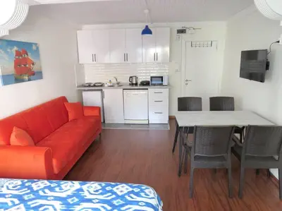 a living room with a red couch and a table at Istanberry - Royal Apartments in Istanbul