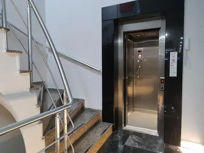 a metal elevator in a building with stairs at Olen Uskudar Hotel in Istanbul