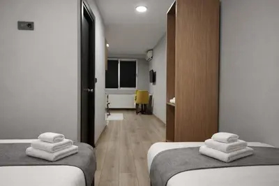 two beds in a room with white towels on them at Olen Uskudar Hotel in Istanbul
