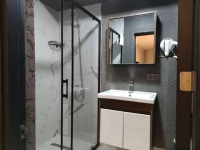 a bathroom with a sink and a shower at Olen Uskudar Hotel in Istanbul