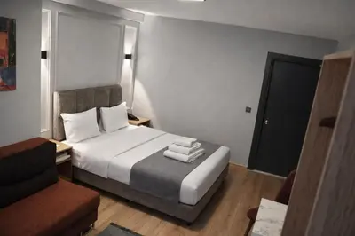 a hotel room with a bed and a chair at Olen Uskudar Hotel in Istanbul