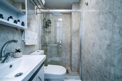 a bathroom with a shower and a toilet and a sink at Elite Marmara Boutique Hotel Sultanahmet in Istanbul