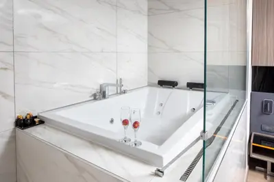 a bath tub with two wine glasses on it at Nish Palace Beşiktaş in Istanbul