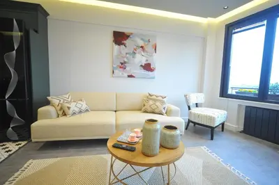 a living room with a couch and a table at sevim suites With a sea view in nişantaşı in Istanbul