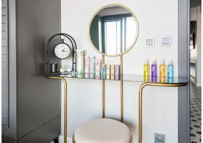 a room with a mirror and a stool and a shelf at sevim suites With a sea view in nişantaşı in Istanbul