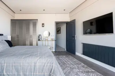 a bedroom with a bed and a flat screen tv at sevim suites With a sea view in nişantaşı in Istanbul
