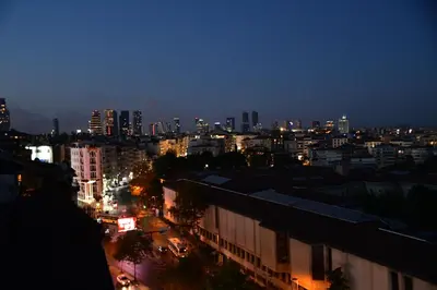 a city skyline at night with buildings and lights at sevim suites With a sea view in nişantaşı in Istanbul