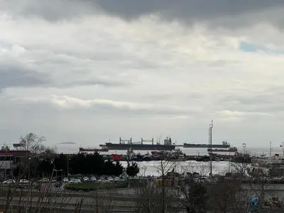 a view of a harbor with cars and a ship at MİRHAN HOTEL in Istanbul